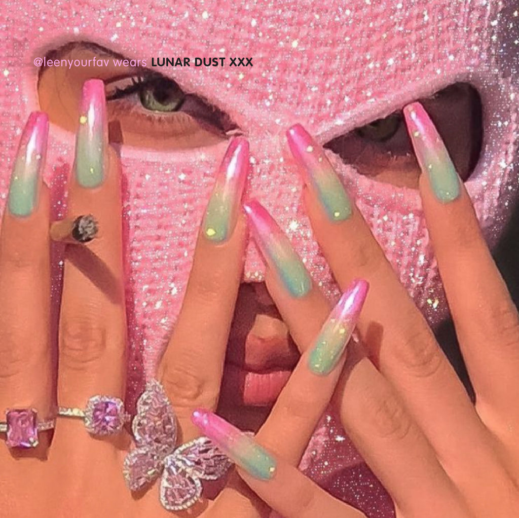 Influencer wearing ultra long coffin press on nails in ombre pink yellow green glitter nails