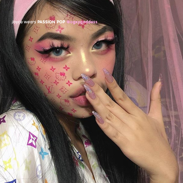 Influencer wearing Tres She instant acrylic press on nails in sheer lilac jelly with holographic glitter in long tapered ballerina shape
