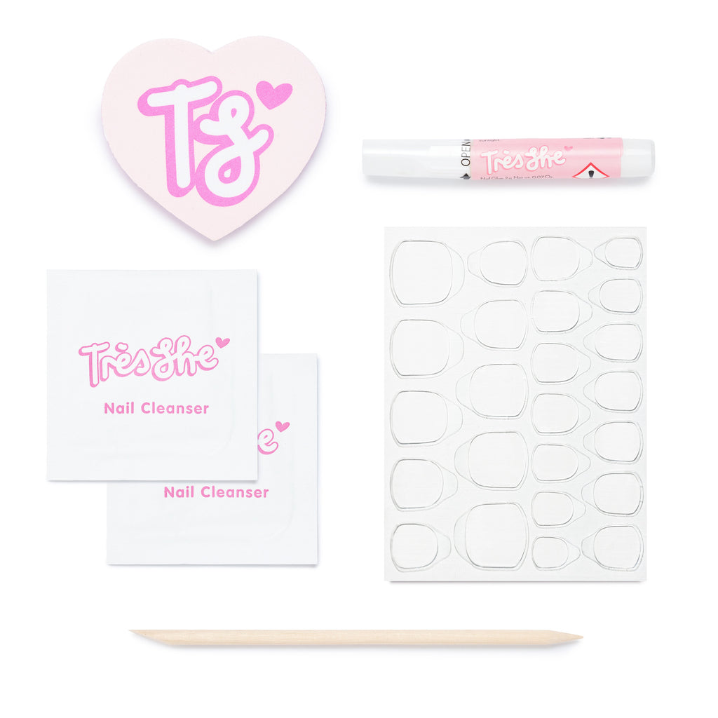 Tres She at home application kit containing nail glue, cuticle stick, alcohol wipes, buffer and stickers